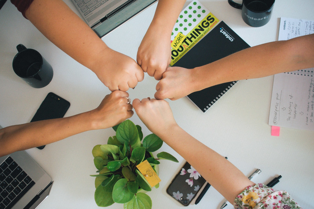 Team putting their hands together in a celebration of success
