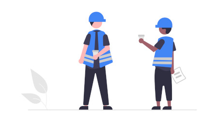 Factory workers in high-vis vests in conversation