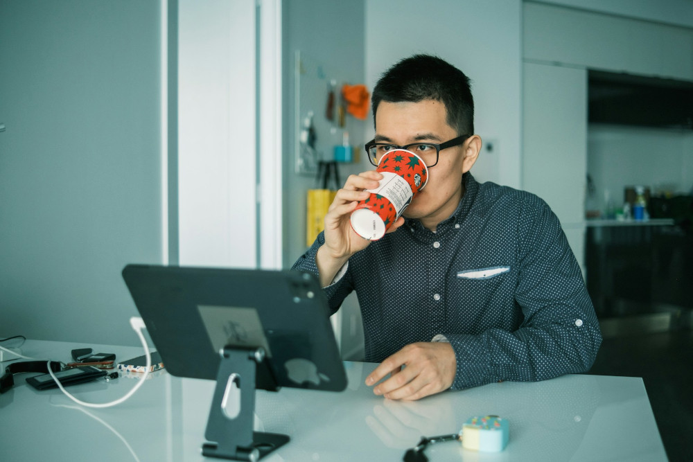 Man with a tablet looking tired and disassociated